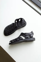 Load image into Gallery viewer, The Barak sandal is lying flat on it&#39;s side, showing it&#39;s buckle side closure and polyurethane out sole and heel. 
