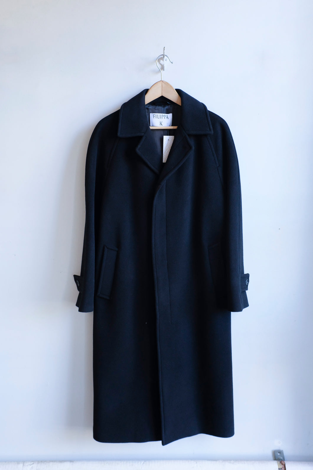 This is a classic black car coat with a relaxed but straight silhouette.