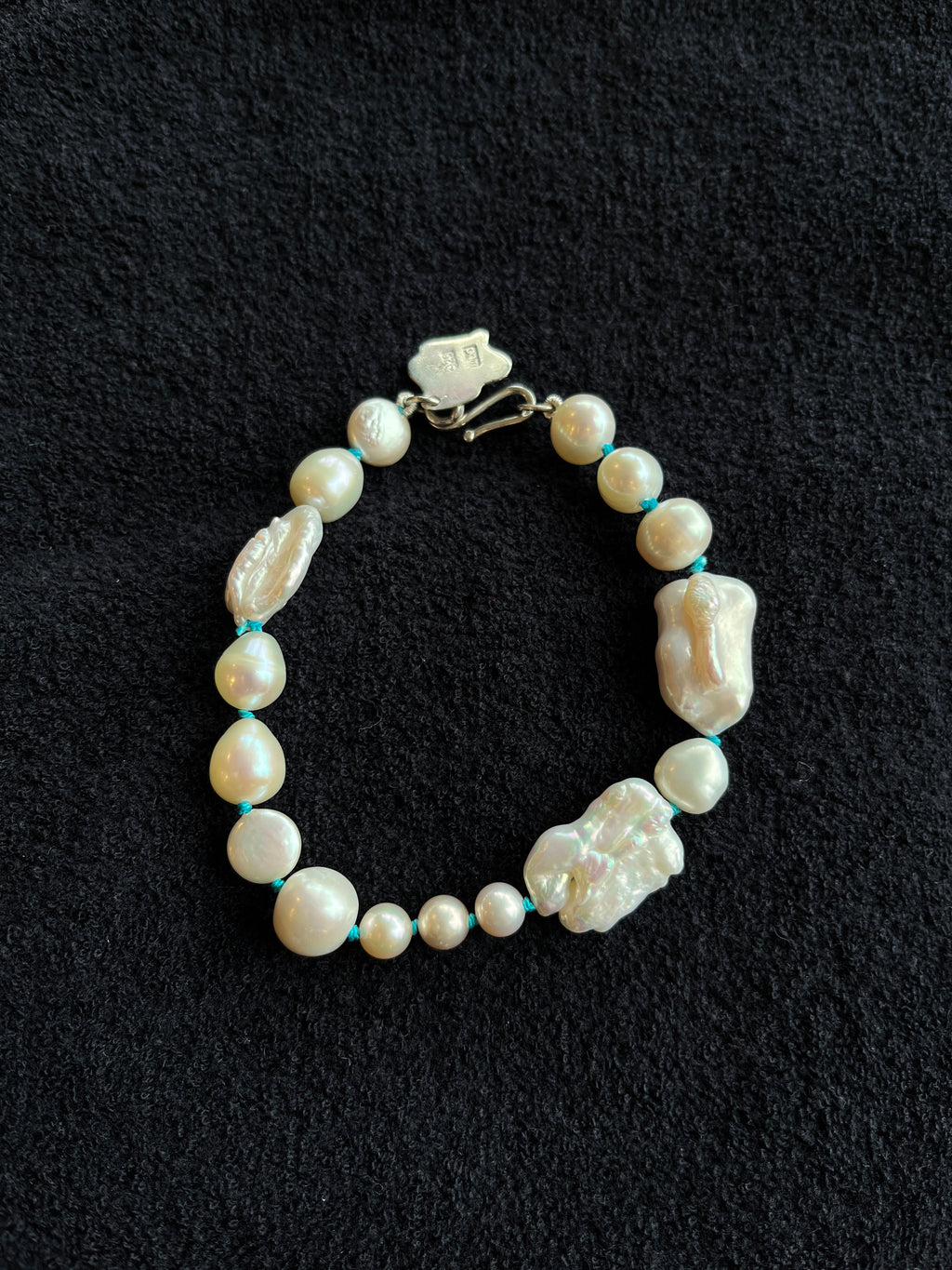 Monica Berdin - Freshwater pearl bracelet with sterling silver clasp on a black background