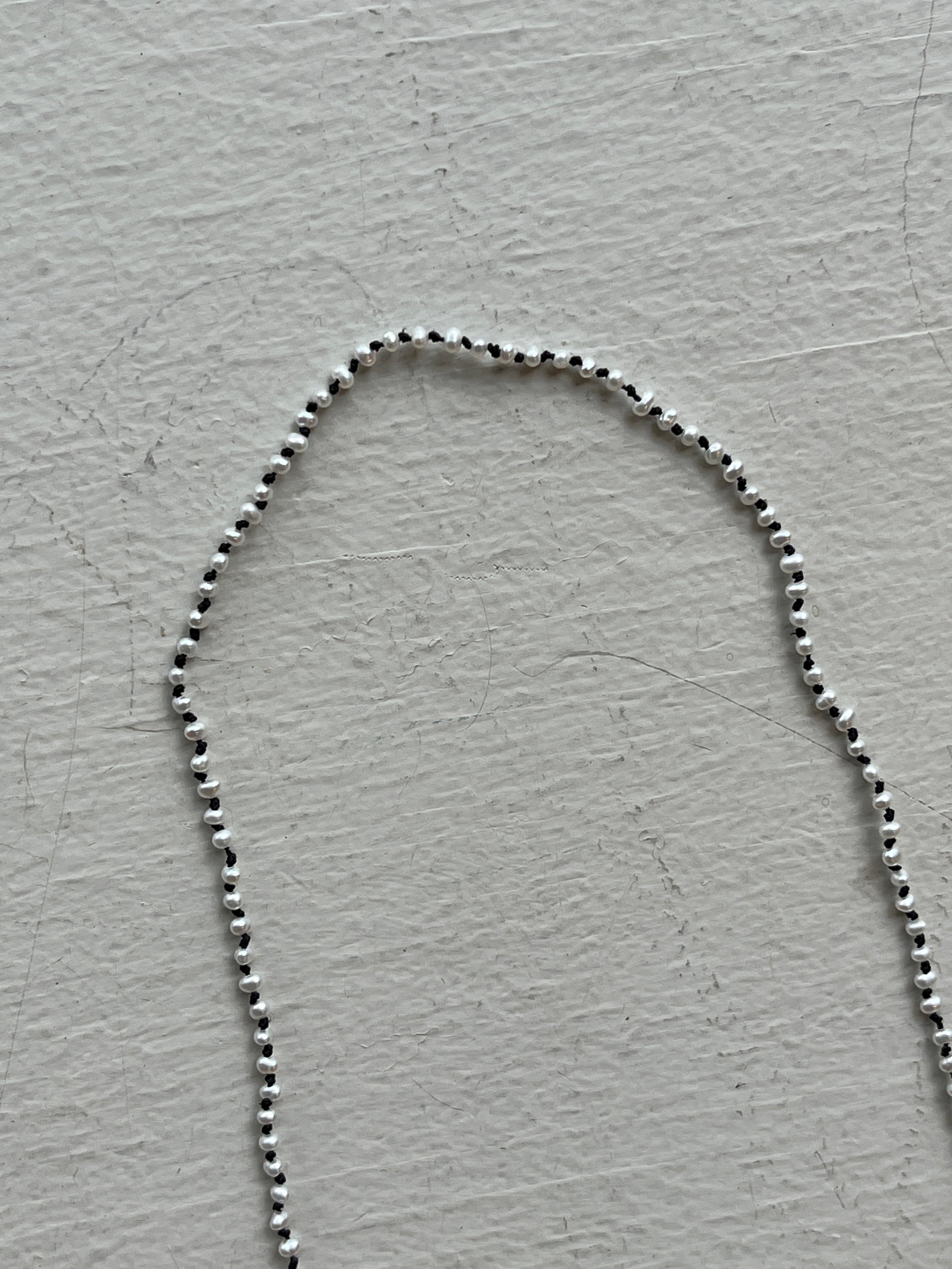 Monica Berdin - Mini pearls necklace on black silk necklace closeup