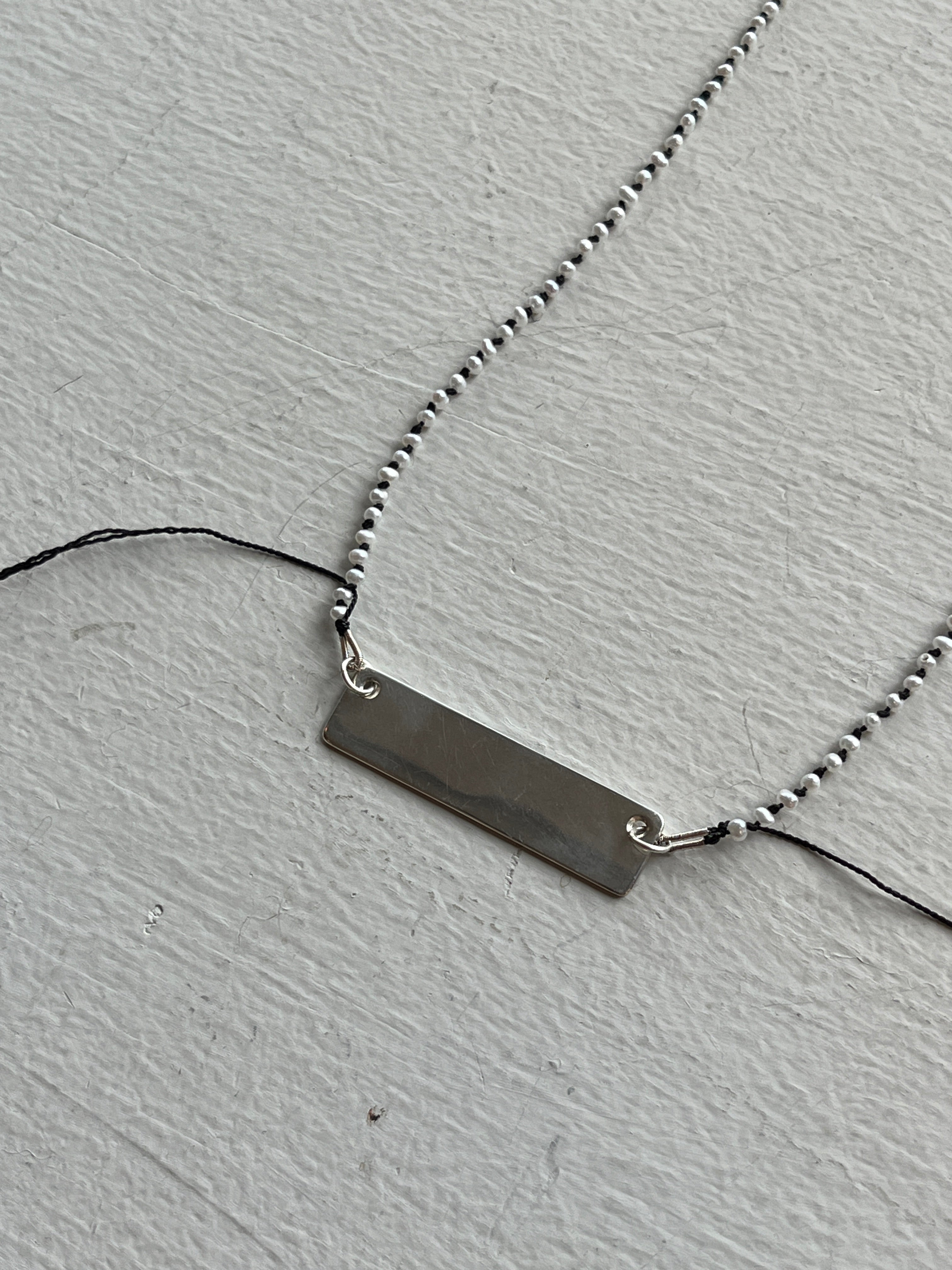 Monica Berdin - Mini pearls necklace on black silk necklace with closeup of sterling silver plate