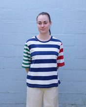 Load image into Gallery viewer, Thinking Mu - Yes T-Shirt - Stripes - front. This t shirt features big bold navy and white horizontal stripes in the torso, red and white stripes of on the left sleeve, and thinner green and white stripes on the right. (from wearer&#39;s perspective) 
