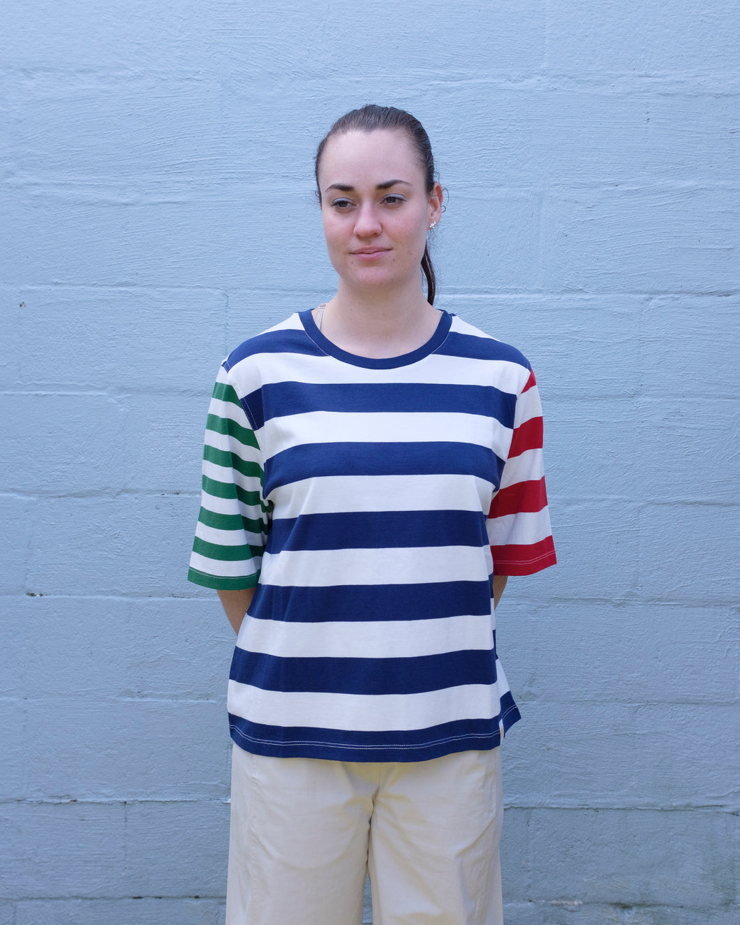 Thinking Mu - Yes T-Shirt - Stripes - front. This t shirt features big bold navy and white horizontal stripes in the torso, red and white stripes of on the left sleeve, and thinner green and white stripes on the right. (from wearer's perspective) 