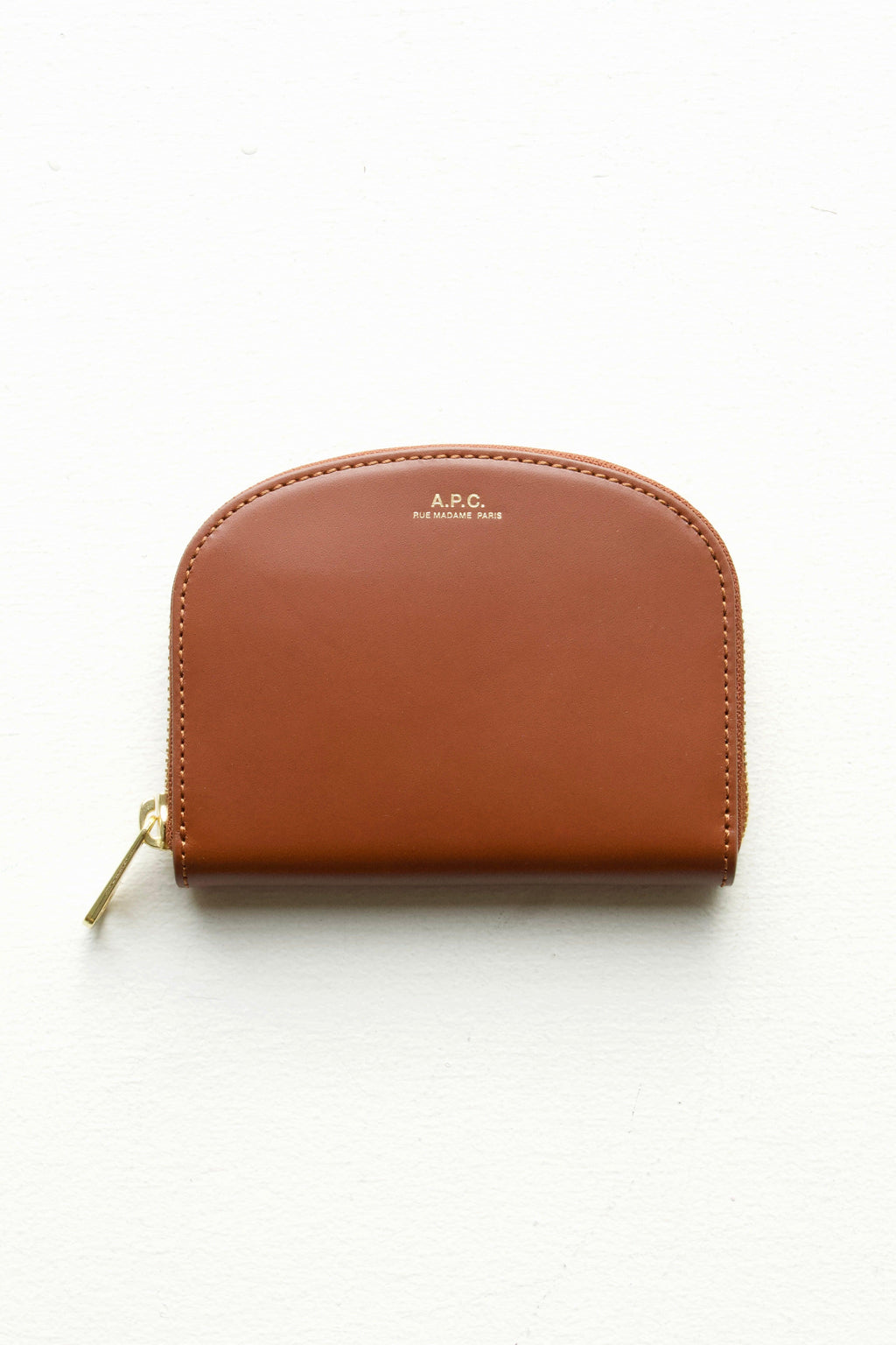 A.P.C Demi-Lune Coin wallet in Hazelnut: this wallet is a warm dark brown in a smooth matte finish