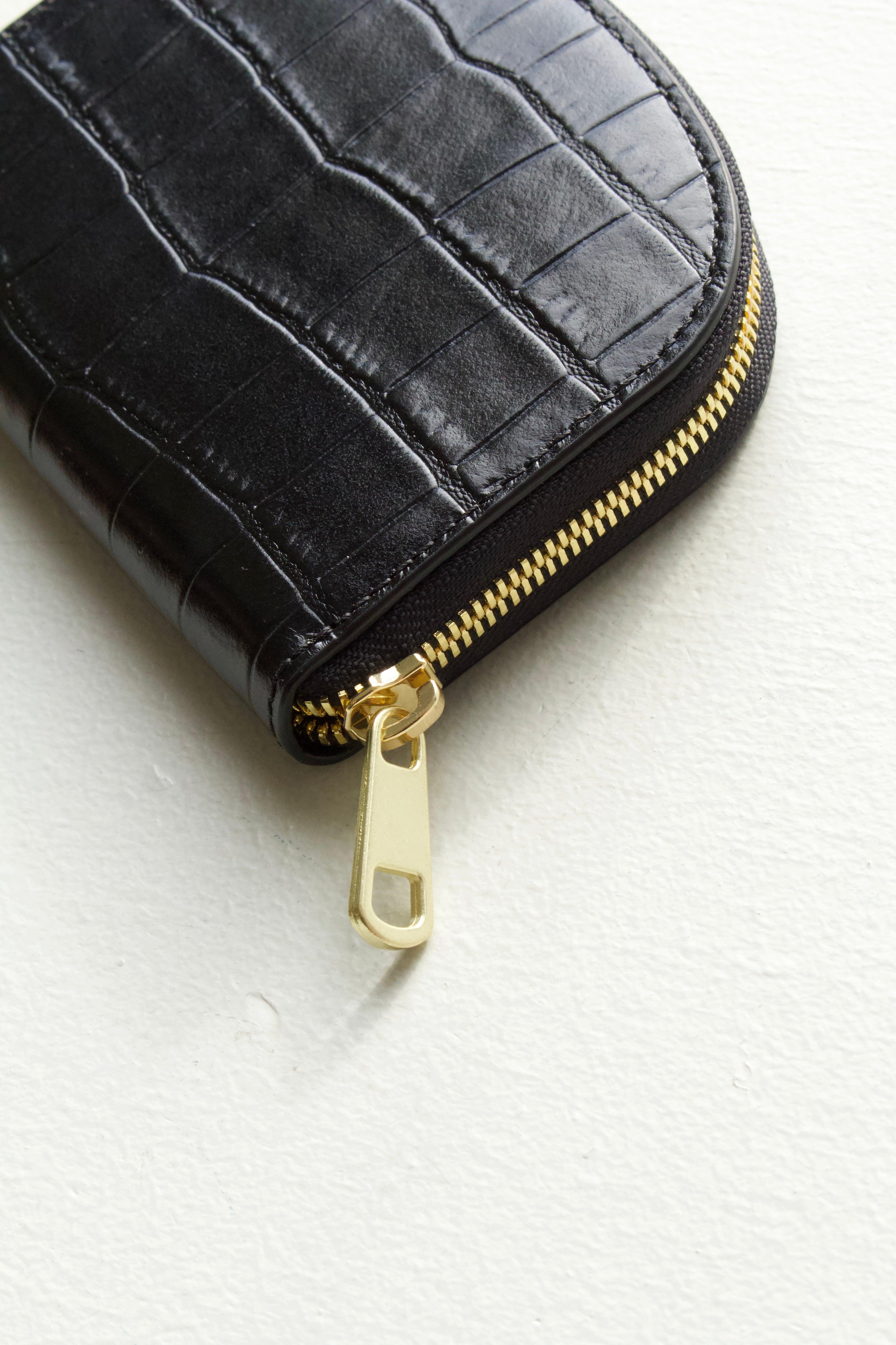 A.P.C Demi-Lune Coin wallet: detail shot of the close up gold tonal zipper