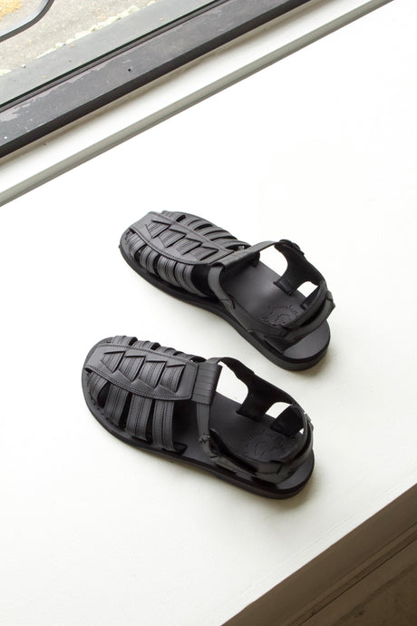 A closed toe fisherman-style black leather sandal for men. 