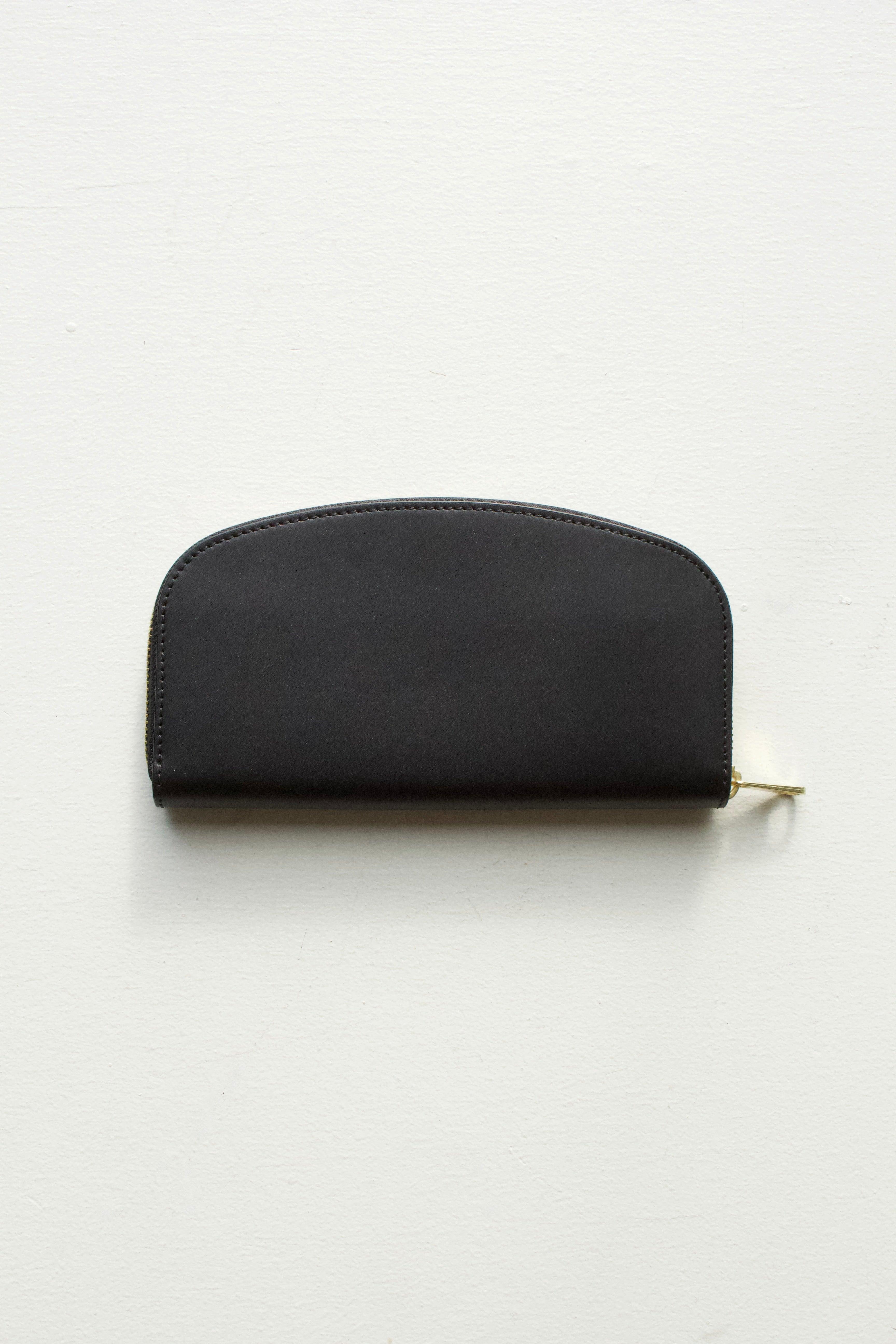 A.P.C Demi-Lune Wallet (Black) - Eugene Choo: this wallet is a true onyx black with gold toned zip around closure