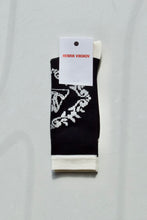 Load image into Gallery viewer, Women&#39;s Black and white Napkin sock from Henrik Vibskov. These stretchy socks come up to about the mid calf and feature a minimal front facing pattern
