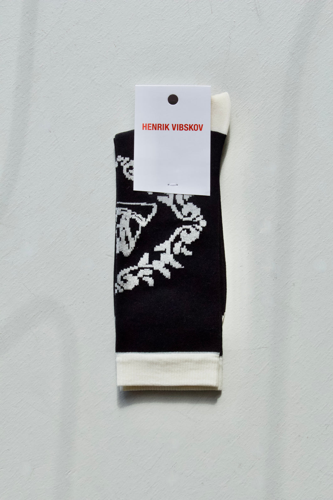 Women's Black and white Napkin sock from Henrik Vibskov. These stretchy socks come up to about the mid calf and feature a minimal front facing pattern