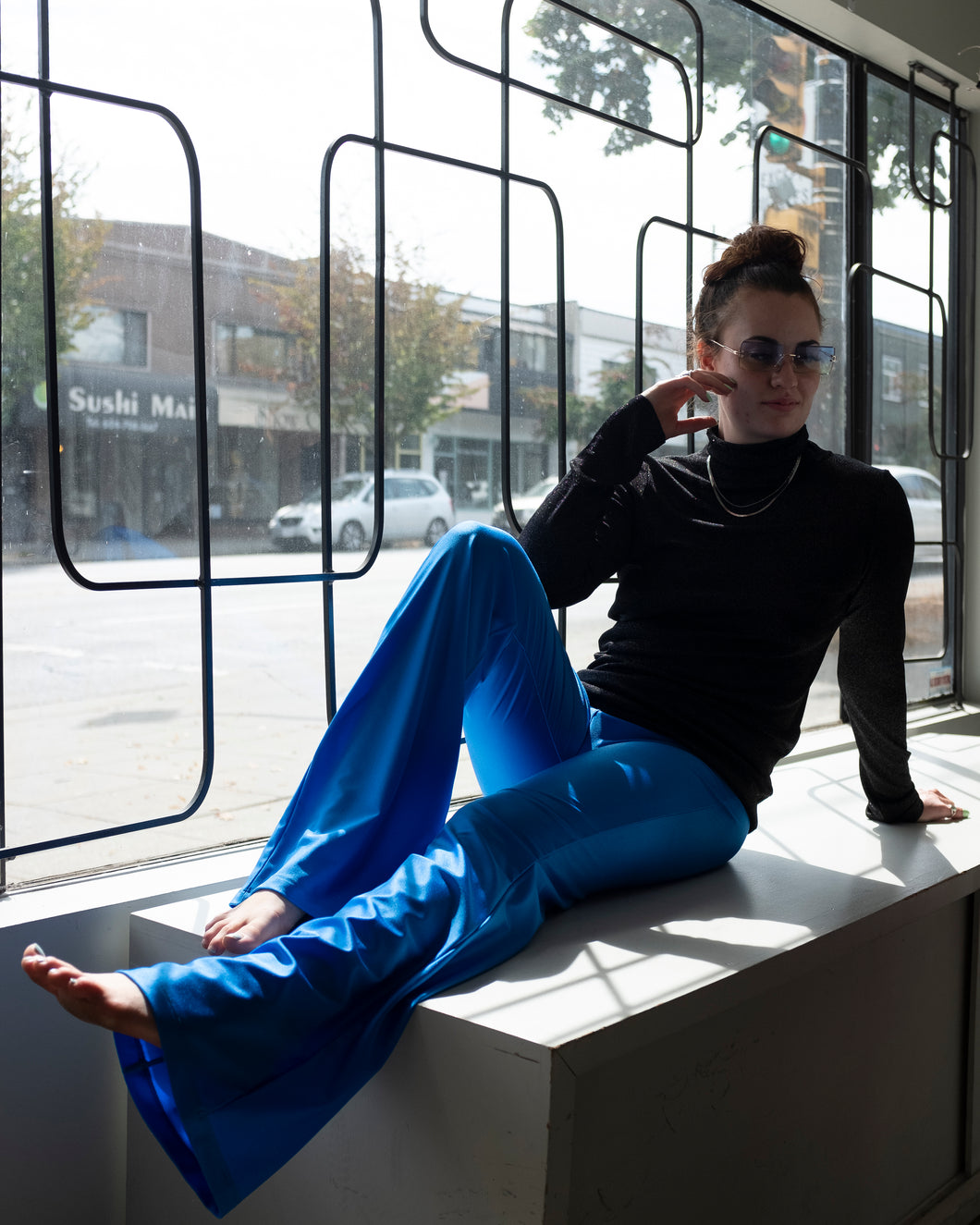 Jamie is lounging on our window display and basking in the sun in the Shimmer Bootcut Legging and Caroline Turtleneck. Ready for the gym and the party.