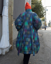 Load image into Gallery viewer, Kildare walking out the alleyway exerting way too much coolness. The halo coat is very cozy and soft, but it is structured, and bellows out below the waist. Waist ties are made front the same material as the rest of the coat, and is sewn into the back.
