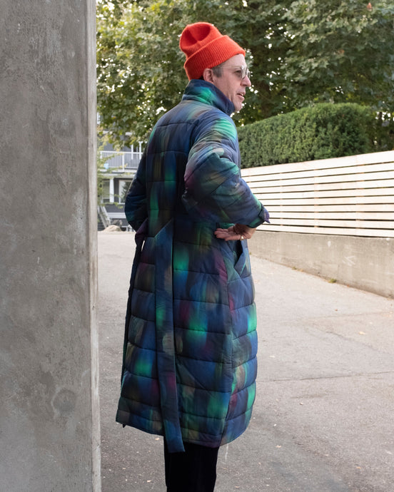 Kildare looking really cool in an alleyway in his Halo coat, nor hat and fishtail pants outfit... the color contract between the blurry dots pattern (blue, green, pink) and the orange nor hat is further sophisticated by the textural addition of oliver spencer's deep navy corduroy fishtail trousers....