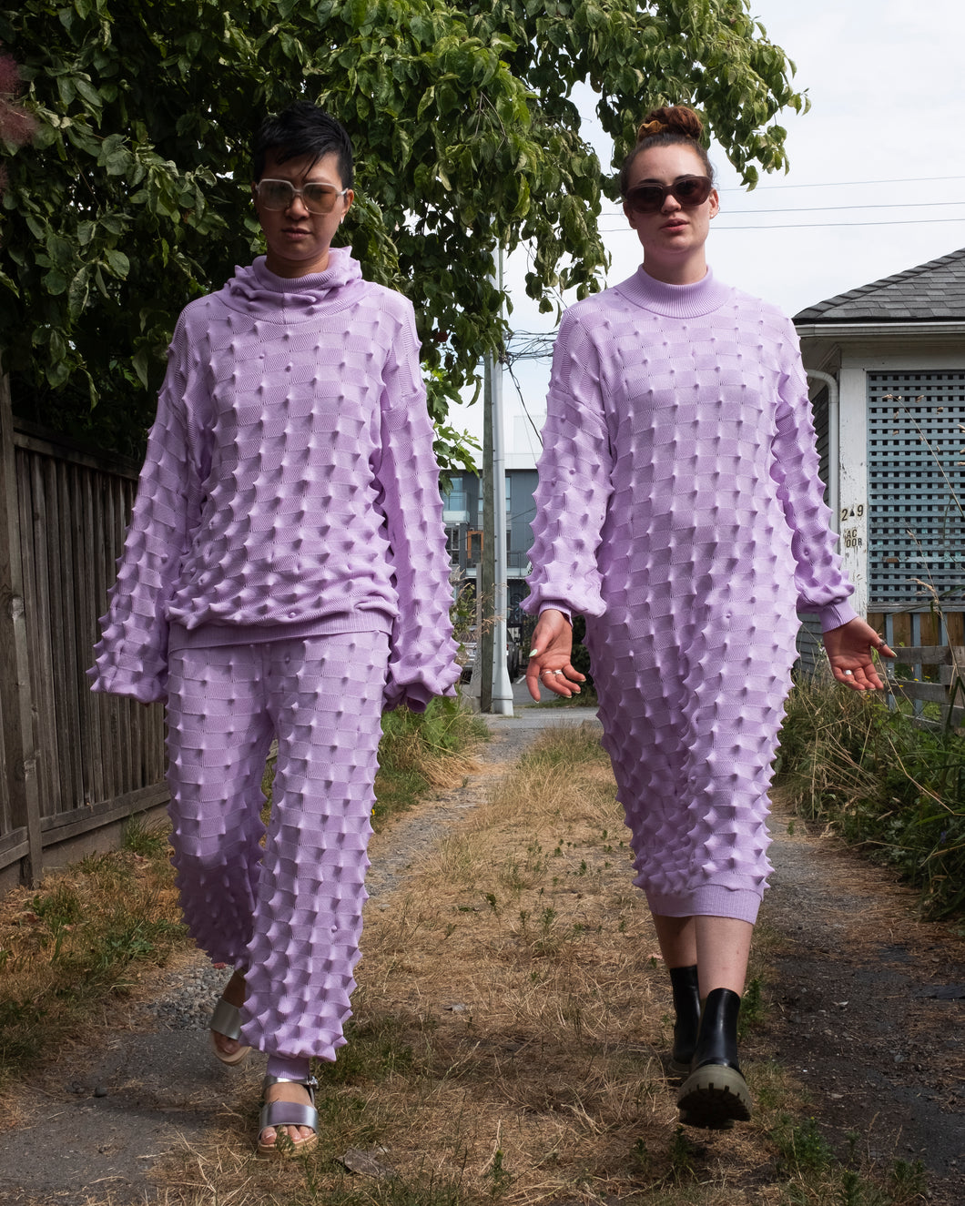Mac and Jamie walking down the alley with attitude in the lavender Spike hoodie, Spike pants and Spike dress.