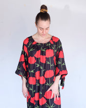 Load image into Gallery viewer, Ka Wa Key - Kullero Maxi Dress - Kullero - on shoulder relaxed sleeve. Jamie is depicted in this image, wearing the Kullero dress on-shoulder (which appears to be a round neck), and sleeves uncinched (a-line sleeve). 
