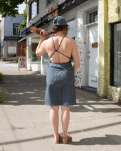 Load image into Gallery viewer, Old Fashion Standards button skirt and 6 panel hat in formal ticking styled with filippa k halter printed swimsuit in blue print and no.6 contour clog in tobacco - back
