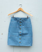 Load image into Gallery viewer, Old fashion standards button skirt in light denim, featuring brass hardware and 6 pockets in total! - flat front
