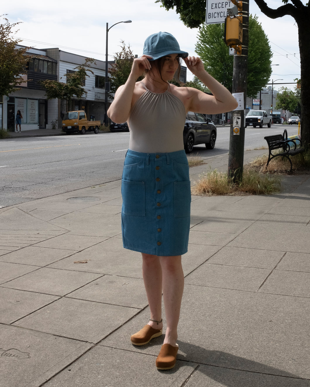 Old fashion standards button skirt and 6 panel cap in light denim styled with filippa k halter printed swimsuit in beige stripe paired with no.6 contour clog in tobacco - front