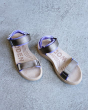 Load image into Gallery viewer, Woden - Line Sandal - Orchid/dark olive- this image depicts the line sandal front a front angle, displaying its orchid (bottom layer soft padding) and dark olive (top layer nylon) straps, paired with a light brown suede-like textured insole with the engravement &quot;woden&quot; and several lines outlining the arch area. 
