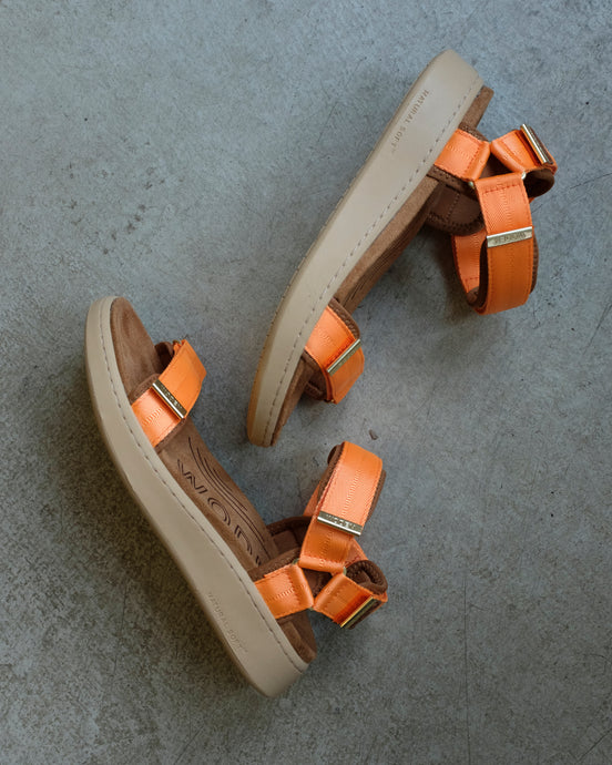 woden - Line Sandal - Tiger - this image depicts the sandals' side profiles. The outsole os a light beige, engraved texts at the bottom reads 